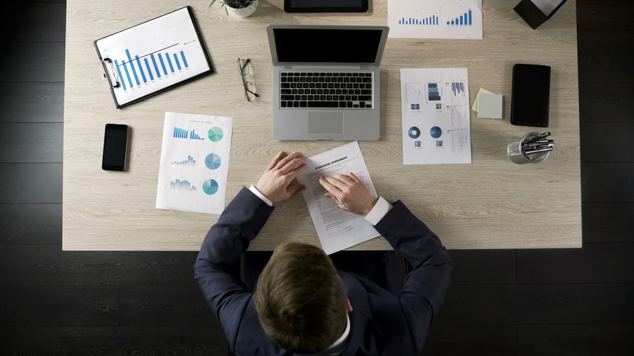 A man looking over a business contract