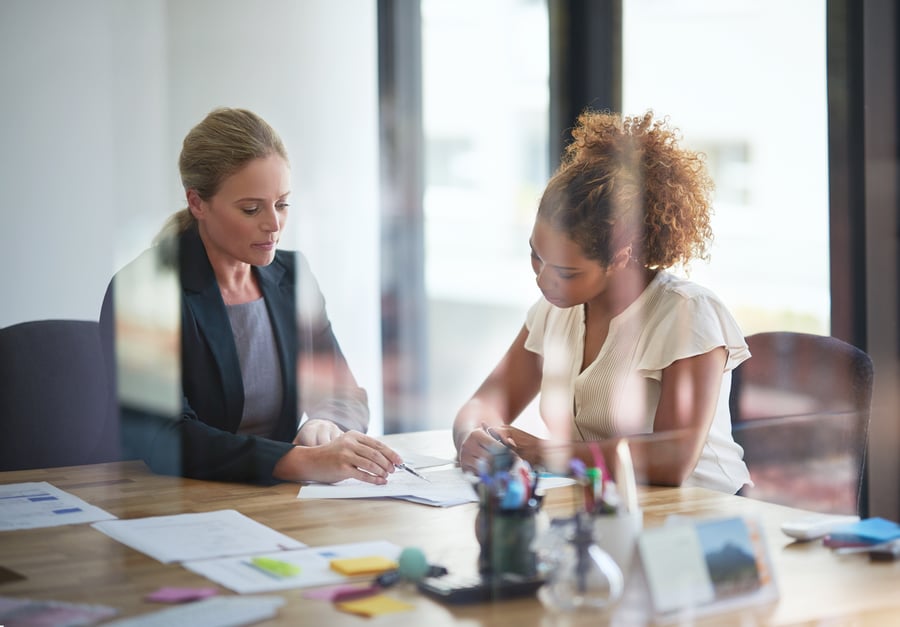 Two women looking over business documents together